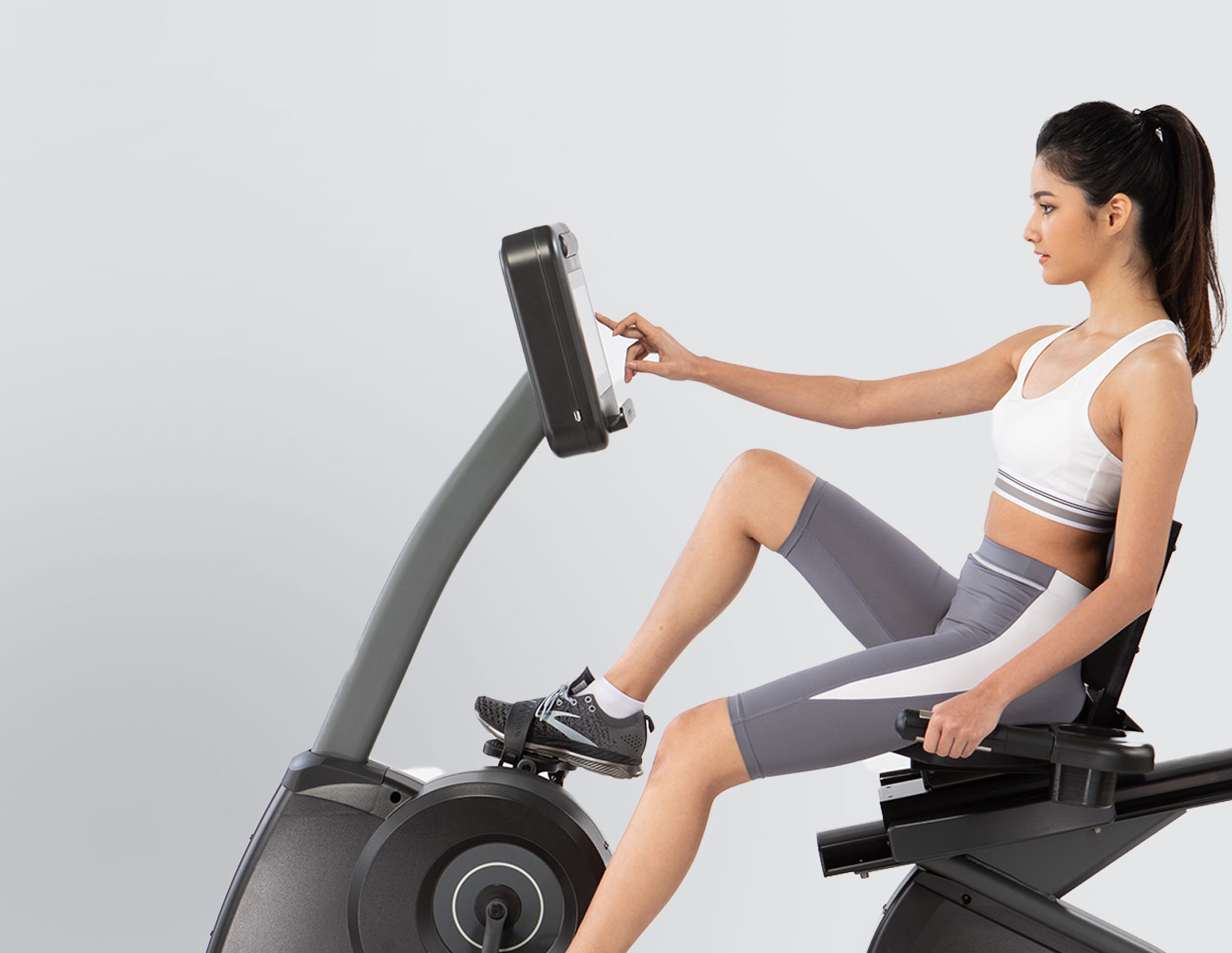 woman setting up fitness bike machine