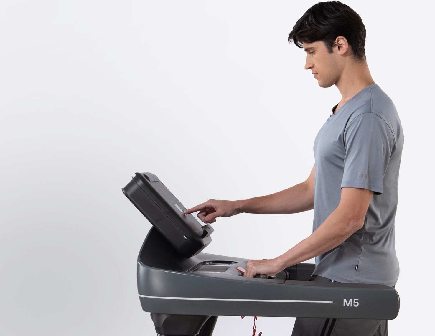 man updating treadmill settings on screen 