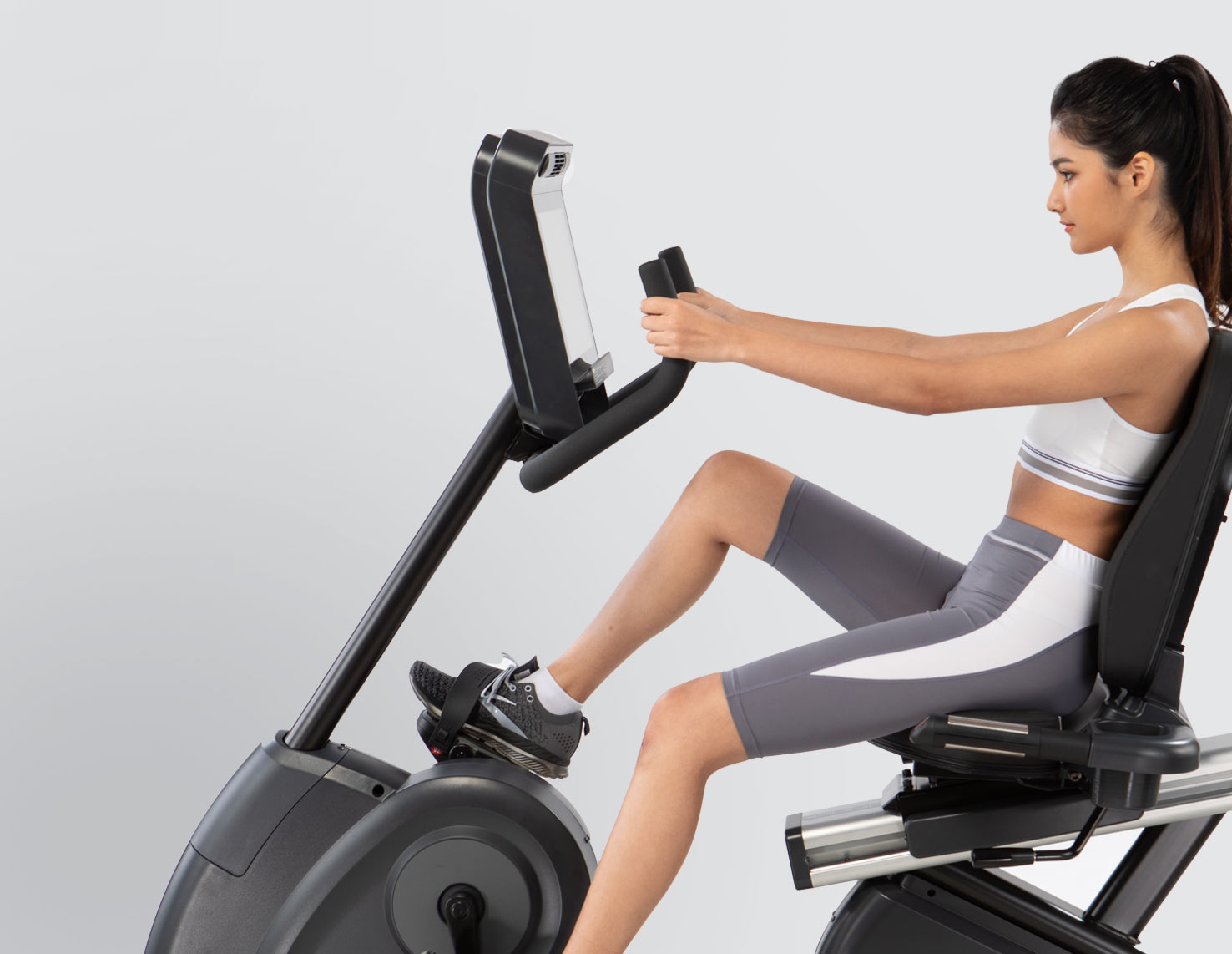 woman cycling on bike machine