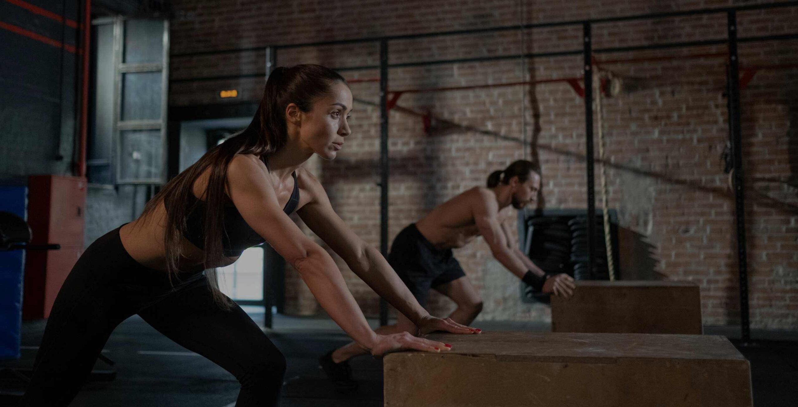 Persons pushing boxes in a gym