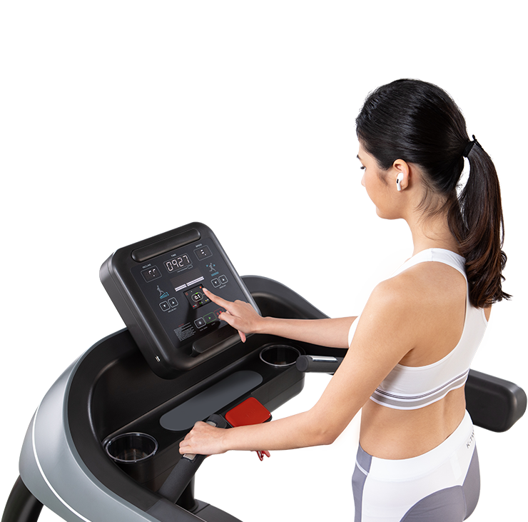 woman touching treadmill screen